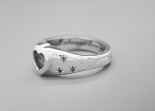 Emily Proudfoot Jewellery - Custom Sapphire heart ring in solid 9k white gold with blue diamonds, holding the clients grandmothers hair remains. Mourning, keepsake, grief fine jewellery.