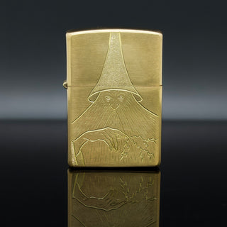 Brass Zippo lighter with engraved wizard-hat scene on the front