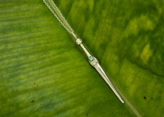 Ceremonial dagger necklace inspired by ancient Egyptian symbolism, featuring a custom birthstone handle and all-seeing eye engraving.