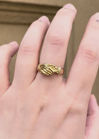Hand wearing a gold hand shake fede wedding band ring diamond birthstone set band, inspired by victorian and medieval commitment jewellery - emily proudfoot