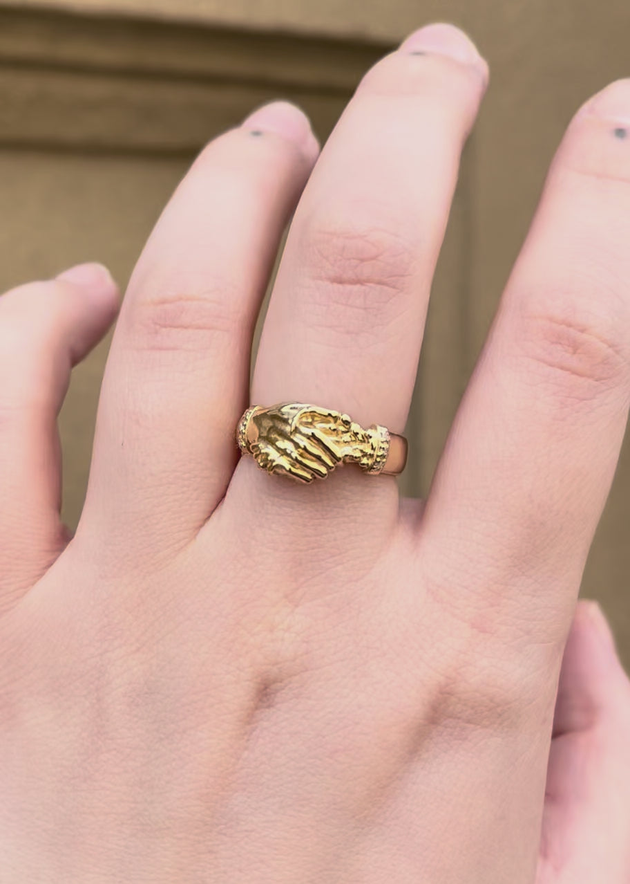 Hand wearing a gold hand shake fede wedding band ring diamond birthstone set band, inspired by victorian and medieval commitment jewellery - emily proudfoot