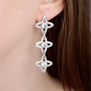 Silver star chain earrings with three clear topaz-like stones, dangling on chain